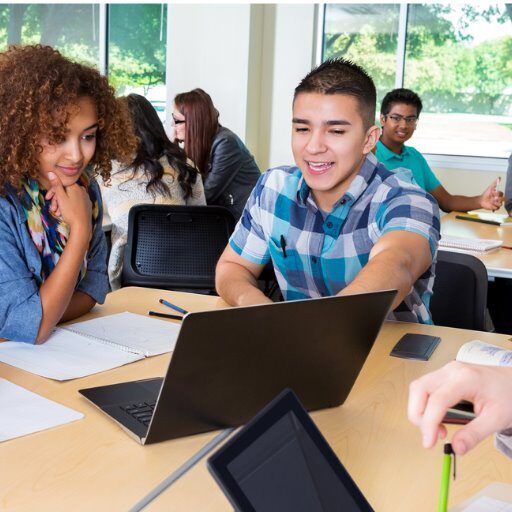 Group of people around a laptop